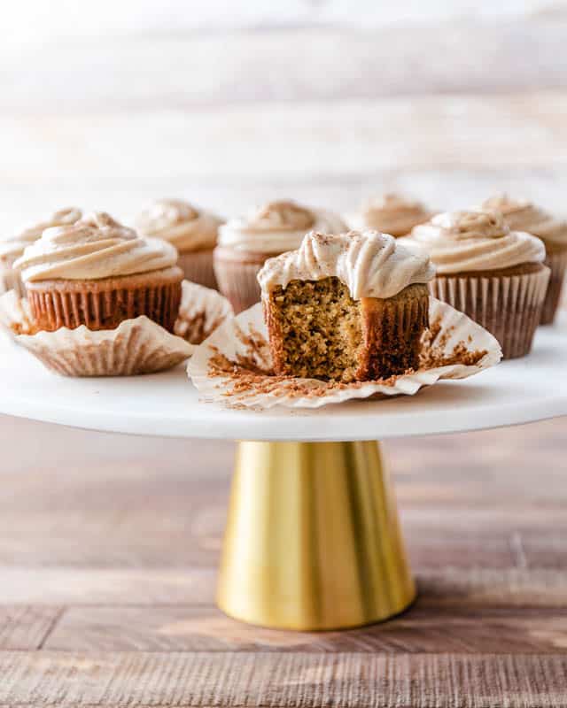 Premium Photo  Scooping pumpkin spice cupcake batter with batter scoop  into a cupcake pan with liners.